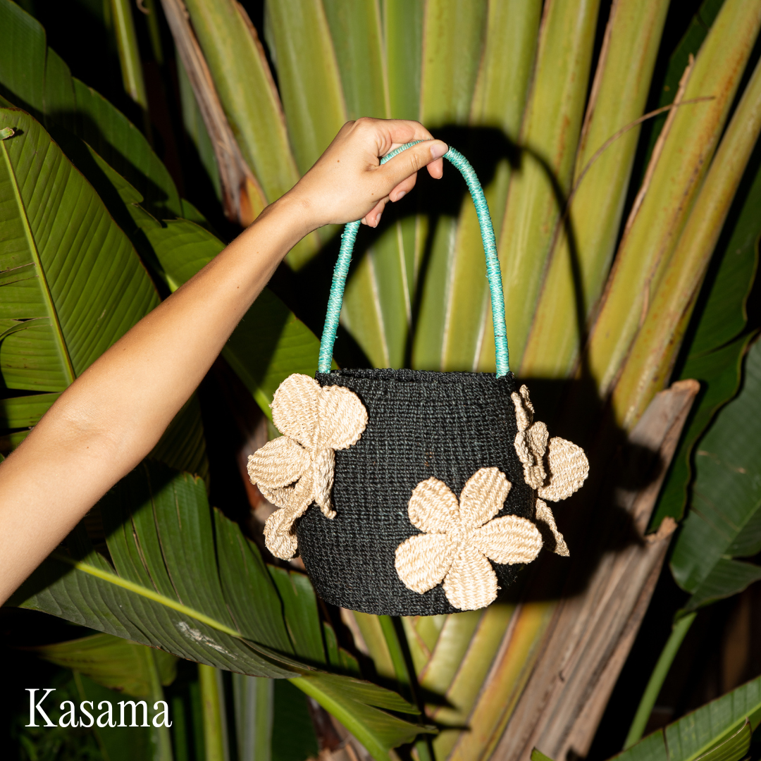 Hand holding a purse with flowers on it