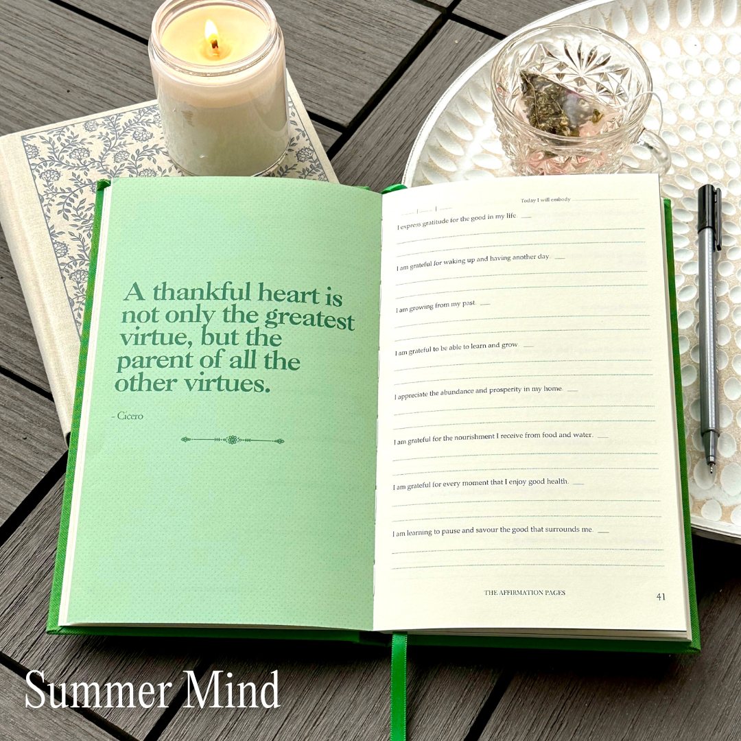 A gratitude journal with green and cream colored pages