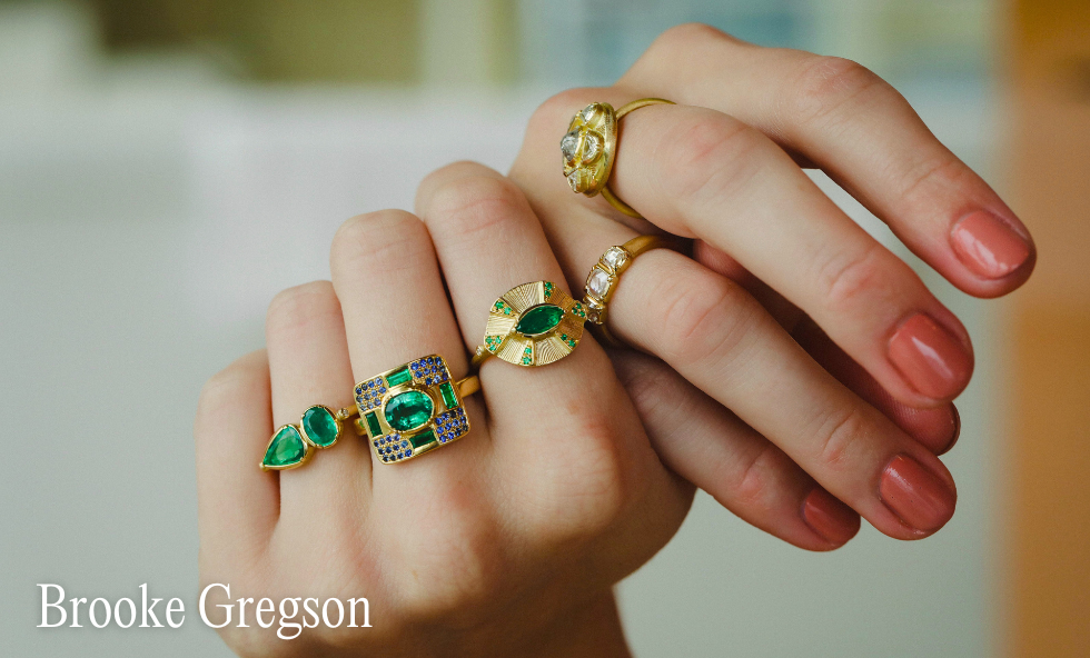 Hands with emerald rings on them